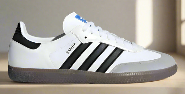 White Adidas sneaker with black stripes on a white background
